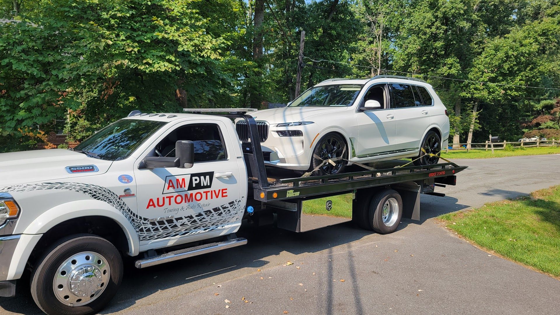 AM PM Towing rollback loading a sedan